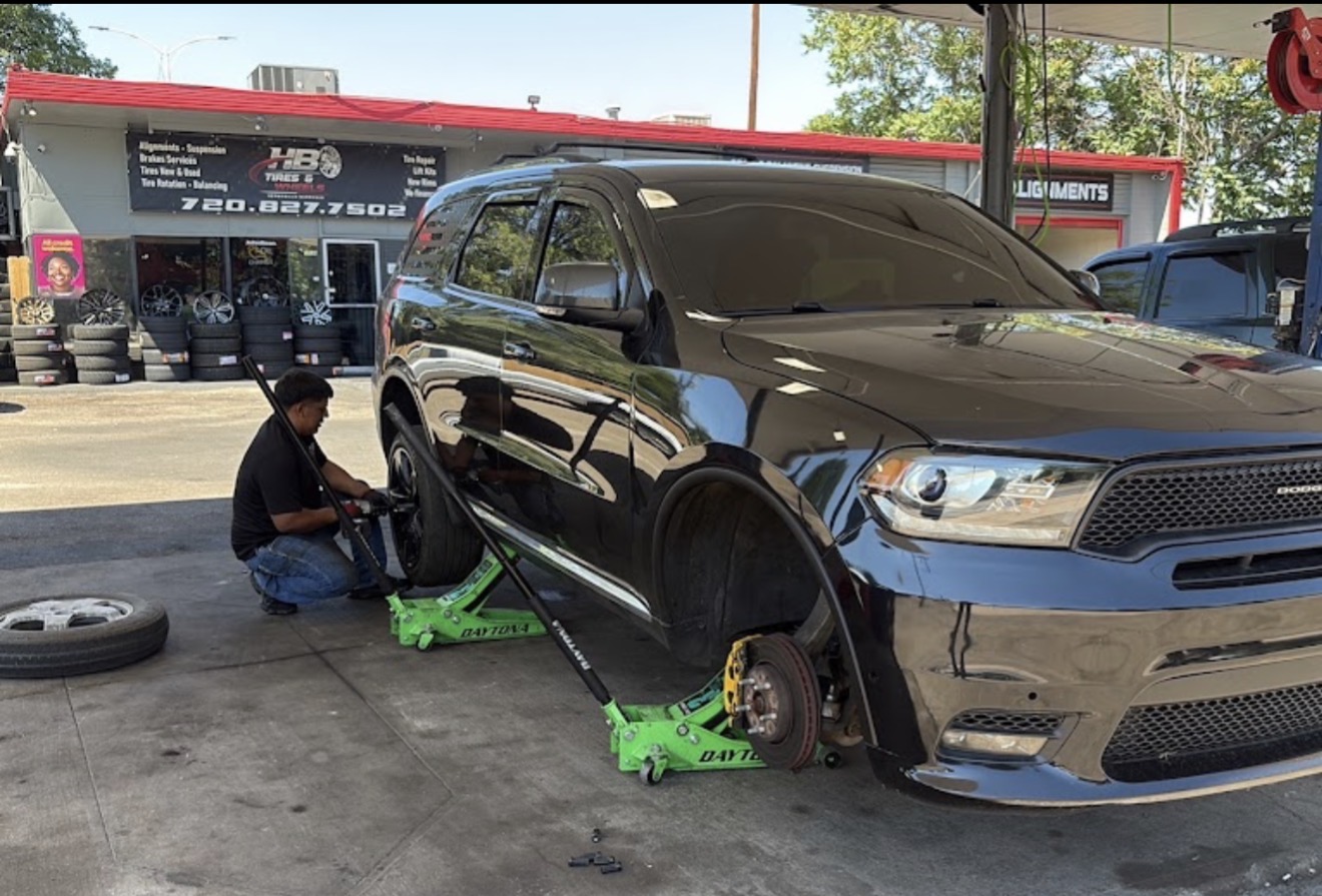HB Tires & Wheels technician installing tires in Denver